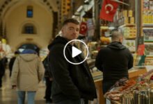 Peter Sutherland in a tense final scene from The Night Agent Season 3, standing in a dimly lit operations room reviewing classified intelligence files.