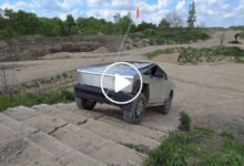 Tesla Cybertruck parked outdoors showcasing its stainless-steel body design during a limited-time pricing opportunity.