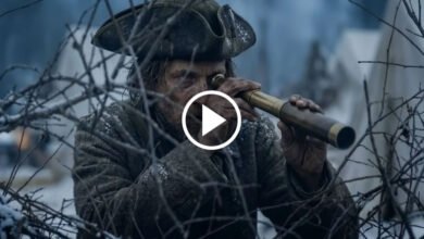 Darren Aronofsky at a film event with digital AI graphics overlay, symbolizing controversy around artificial intelligence in filmmaking.